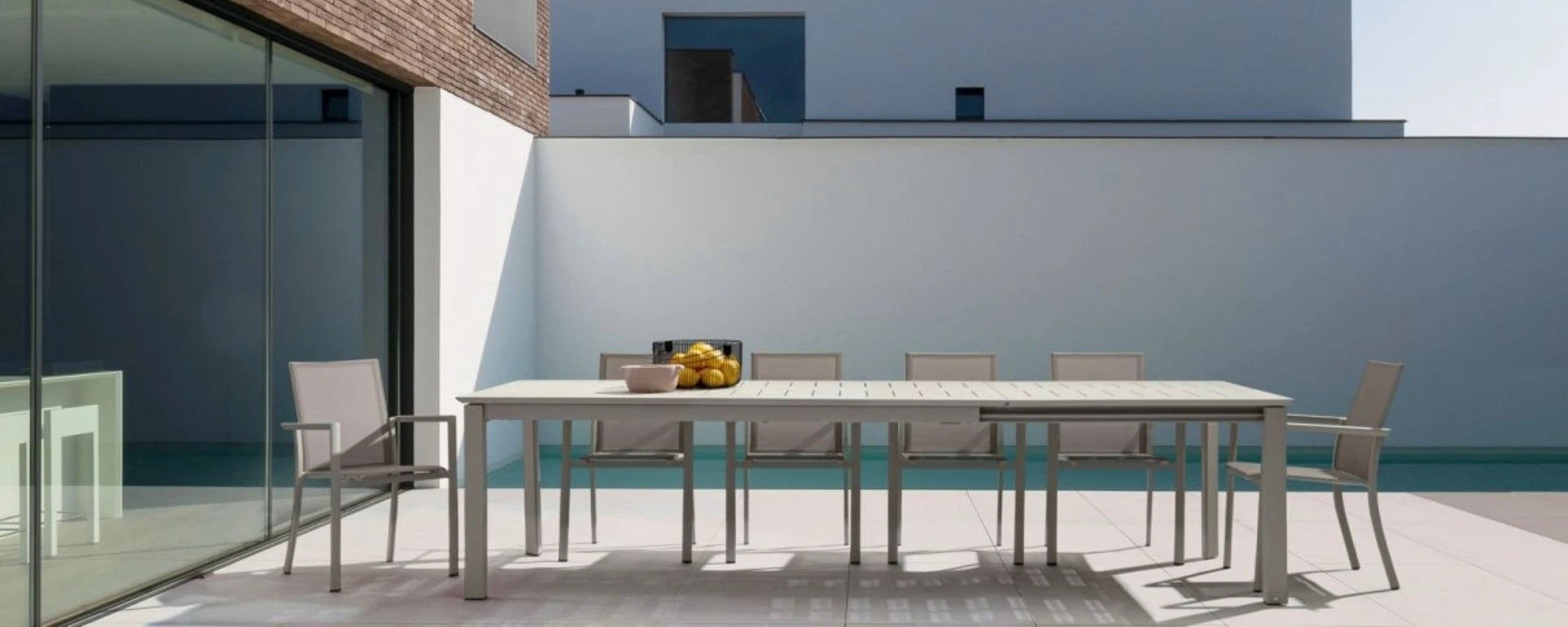 Long Outdoor Dining Table next to Pool